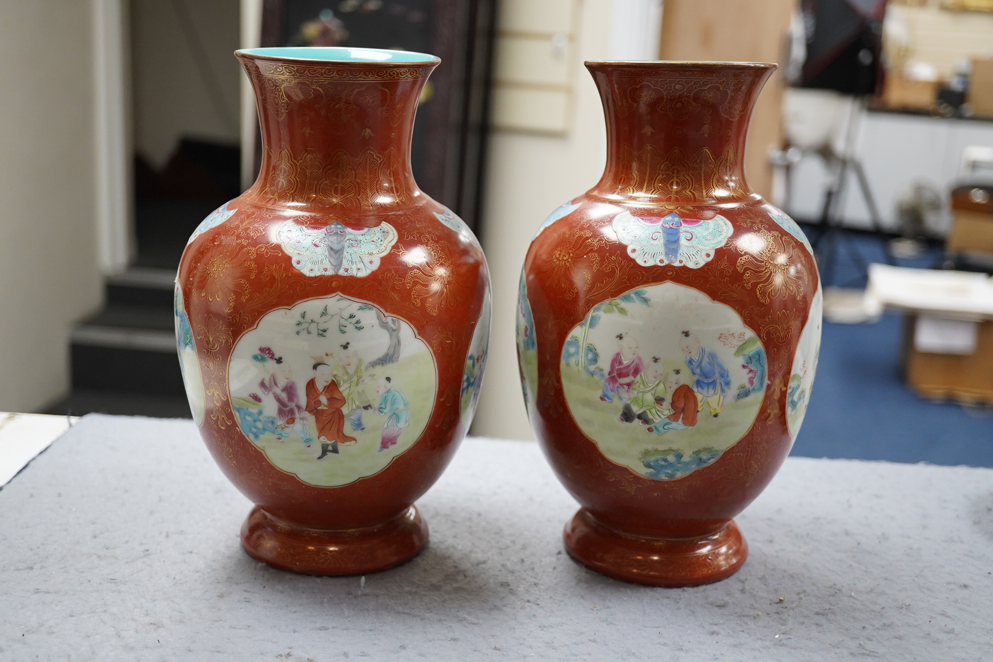 A pair of Chinese coral ground ‘boys’ vases, Jiaqing period (1796-1820)